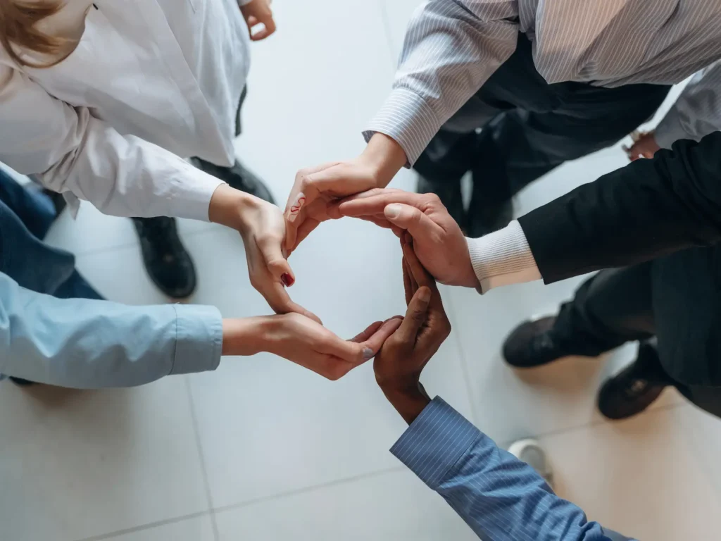 Professional handshake overlay with business silhouettes representing agency growth and partnership